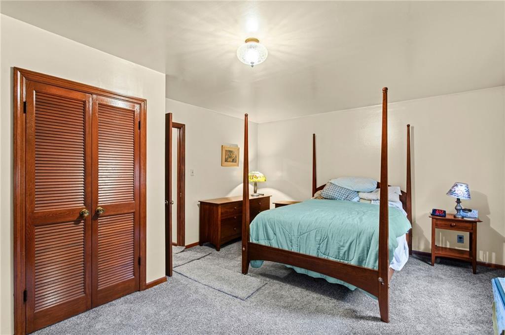 1445 Dutch Ridge Road Beaver, PA 15009 - Photo 27 of 43 a bedroom with bed and a chandelier