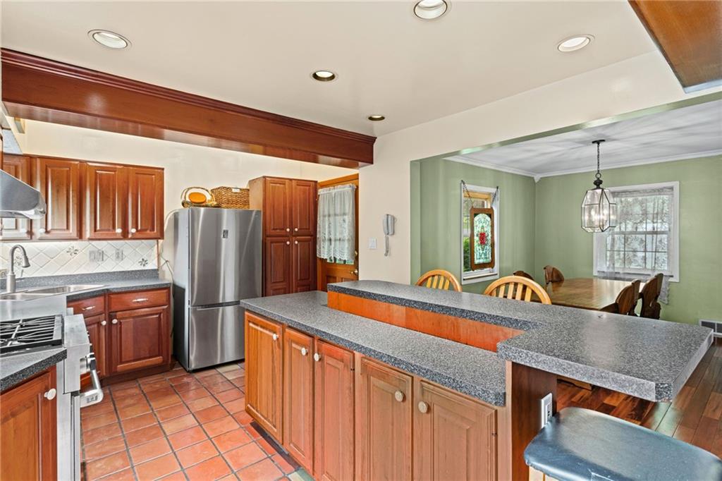 1445 Dutch Ridge Road Beaver, PA 15009 - Photo 8 of 43 a kitchen with stainless steel appliances granite countertop a sink and a refrigerator