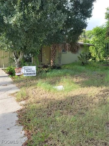 a view of a backyard with large trees
