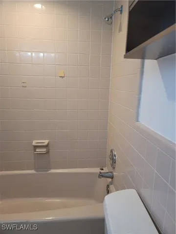 a bathroom with a bathtub and toilet
