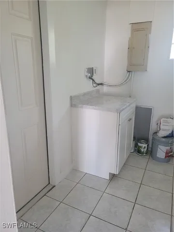 a bathroom with a granite countertop sink and a toilet
