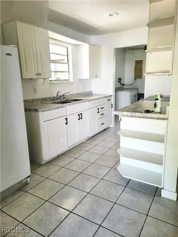 a kitchen with a stove a sink and a refrigerator