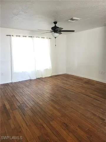 a view of a room with wooden floor