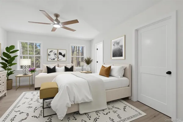 a bedroom with a large bed and a window