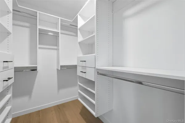 a view of walk in closet with empty racks
