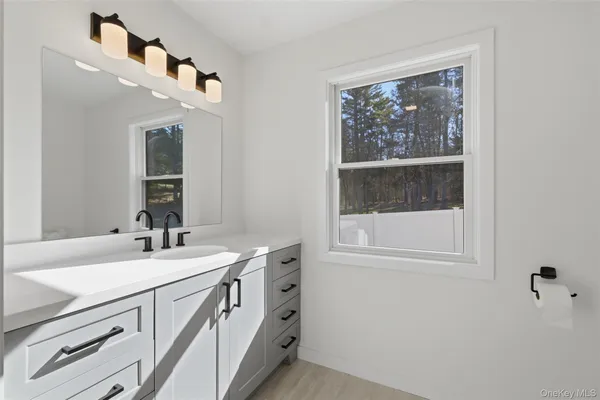 a bathroom with a sink a vanity and a mirror