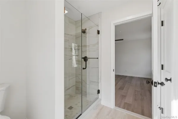 a bathroom with a glass shower door