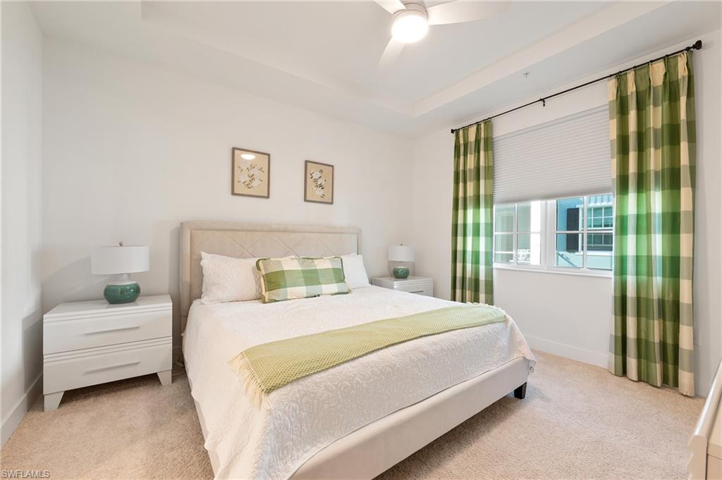 26401 Coco Cay Circle, Unit 101 Bonita Springs, FL 34135 - Photo 13 of 27 a bedroom with a bed and a large window