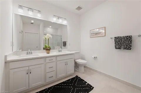a bathroom with a toilet sink and a mirror