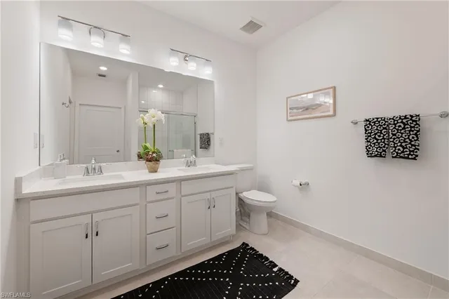 a bathroom with a toilet sink and a mirror