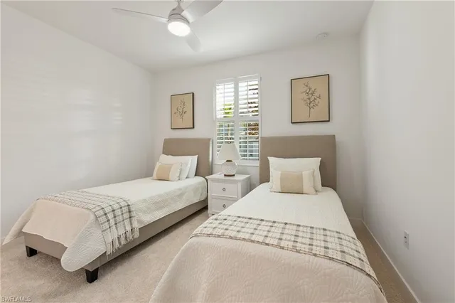 a bedroom with two beds and painting on the wall