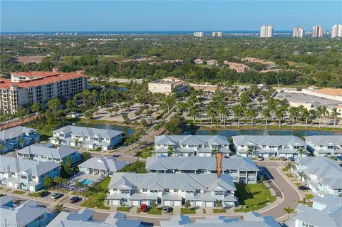 an aerial view of residential building and lake