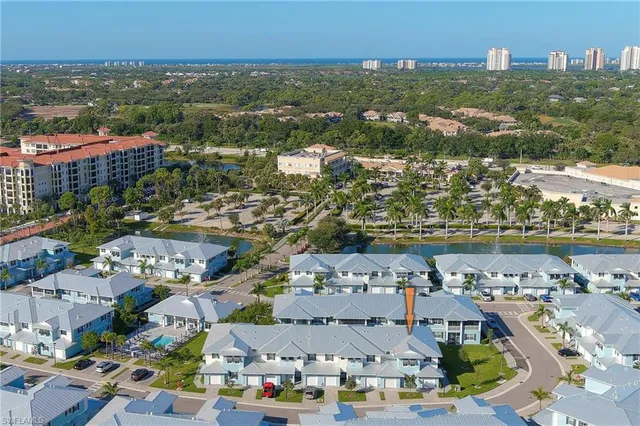 an aerial view of residential building and lake