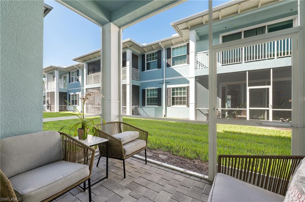 26401 Coco Cay Circle, Unit 101 Bonita Springs, FL 34135 - Photo 21 of 27 a view of a house with a backyard and porch