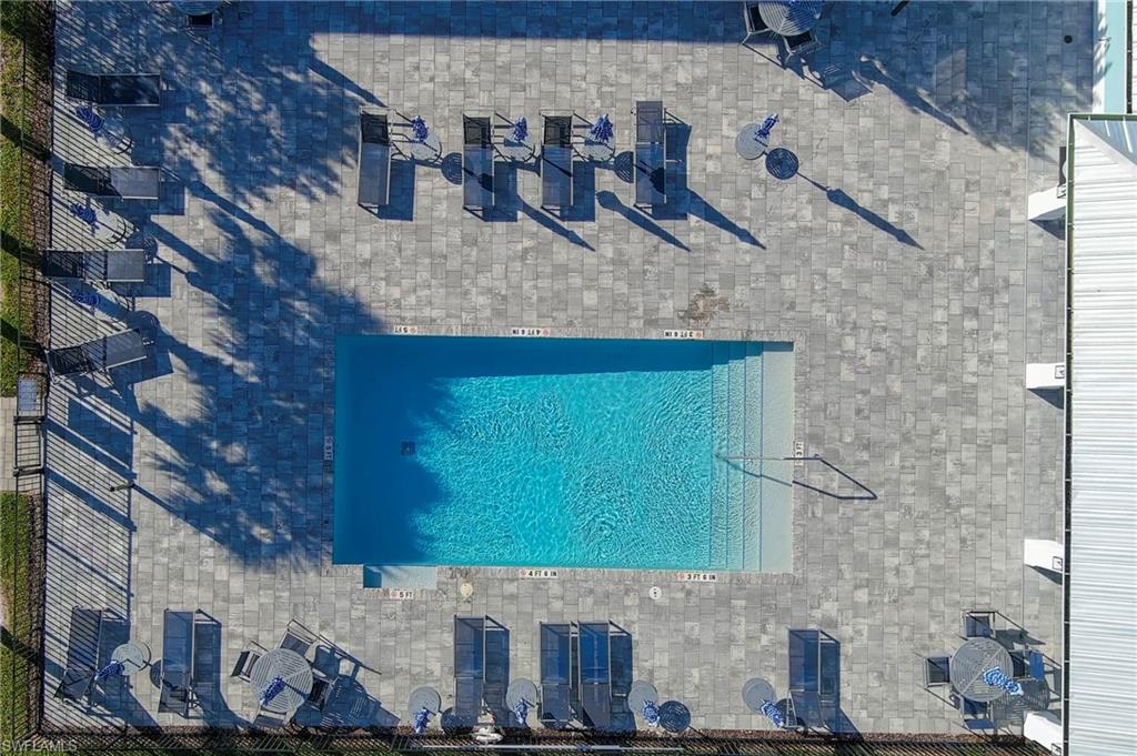 26401 Coco Cay Circle, Unit 101 Bonita Springs, FL 34135 - Photo 24 of 27 a bathroom with a sink and a mirror