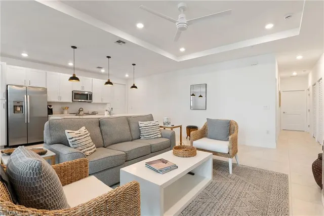 a living room with furniture kitchen and a table