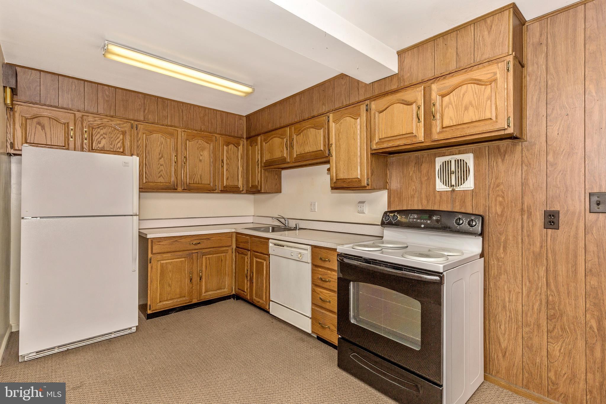 3929 Weller Road Silver Spring, MD 20906 - Photo 13 of 54 a kitchen with stainless steel appliances granite countertop a stove a refrigerator and a sink