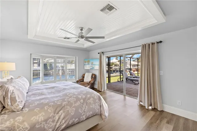 a bed sitting in a spacious bedroom next to a window