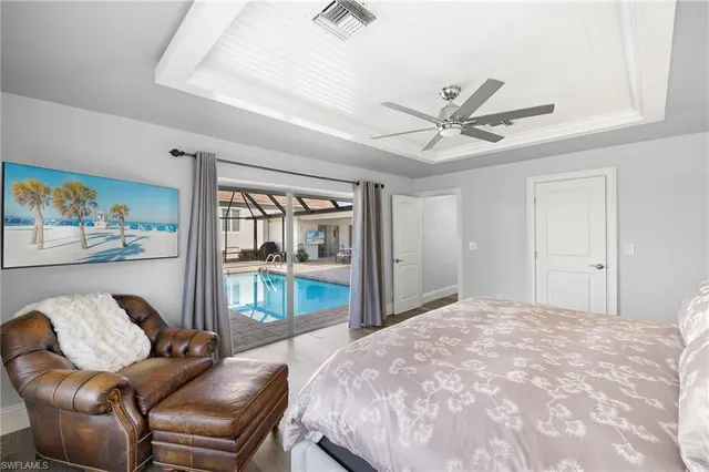 a bedroom with a large bed couch and a window