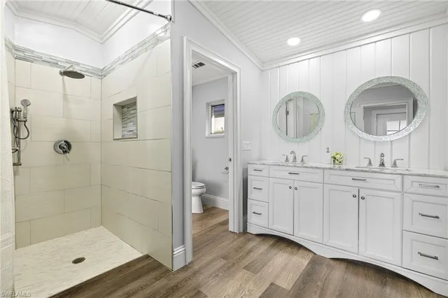 a bathroom with double vanity sink and a mirror