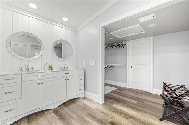 a spacious bathroom with a granite countertop sink a mirror and a shower