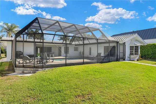a view of a house with swimming pool and porch