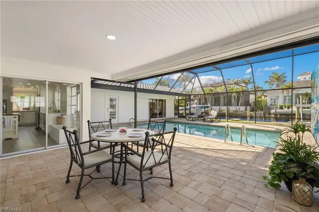 a view of a patio with table and chairs and potted plants