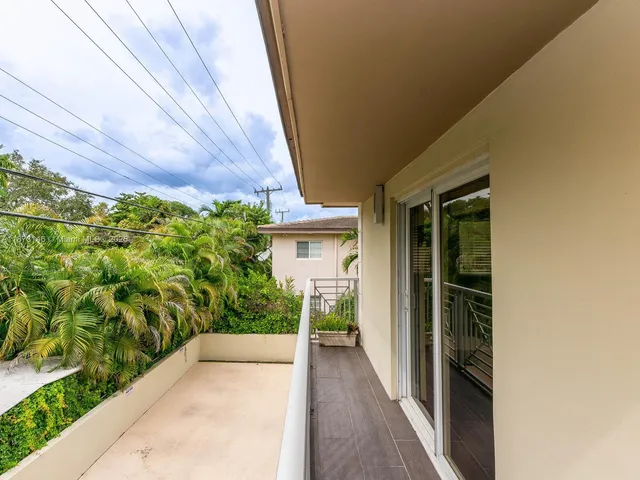 a view of a pathway of a house with a yard