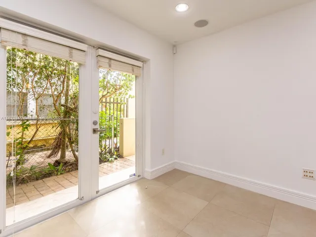 a view of an empty room and a window