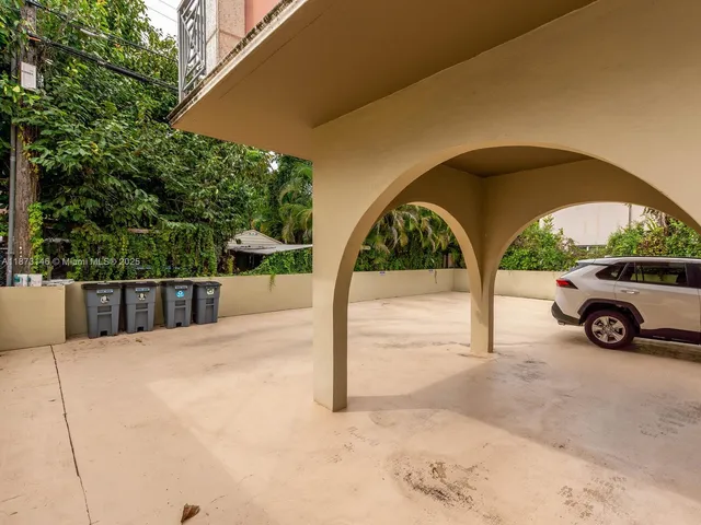 a view of street with a car parked in front of it