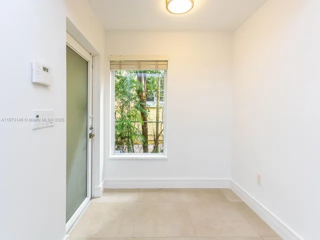 a view of an empty room with a window