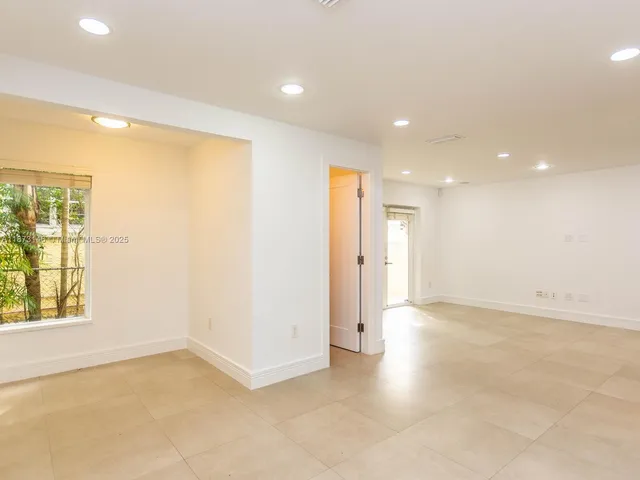 an empty room with windows and entrance