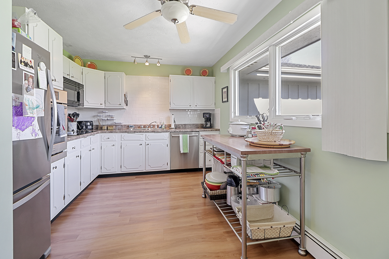1725 Robert Drive Champaign, IL 61821 - Photo 8 of 18 a kitchen with a sink chairs and cabinets