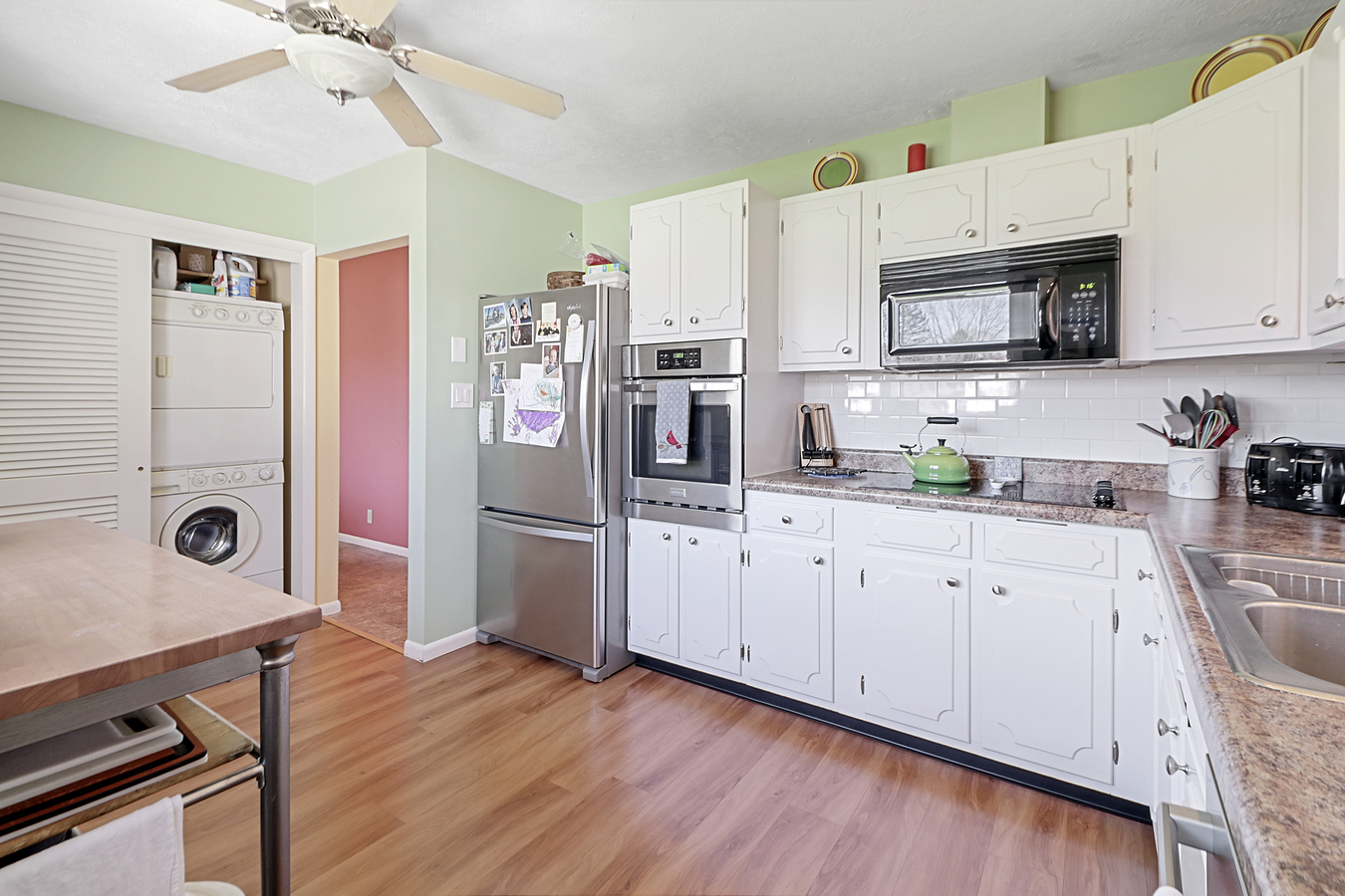 1725 Robert Drive Champaign, IL 61821 - Photo 9 of 18 a kitchen with stainless steel appliances granite countertop a refrigerator a stove a sink dishwasher and white cabinets with wooden floor