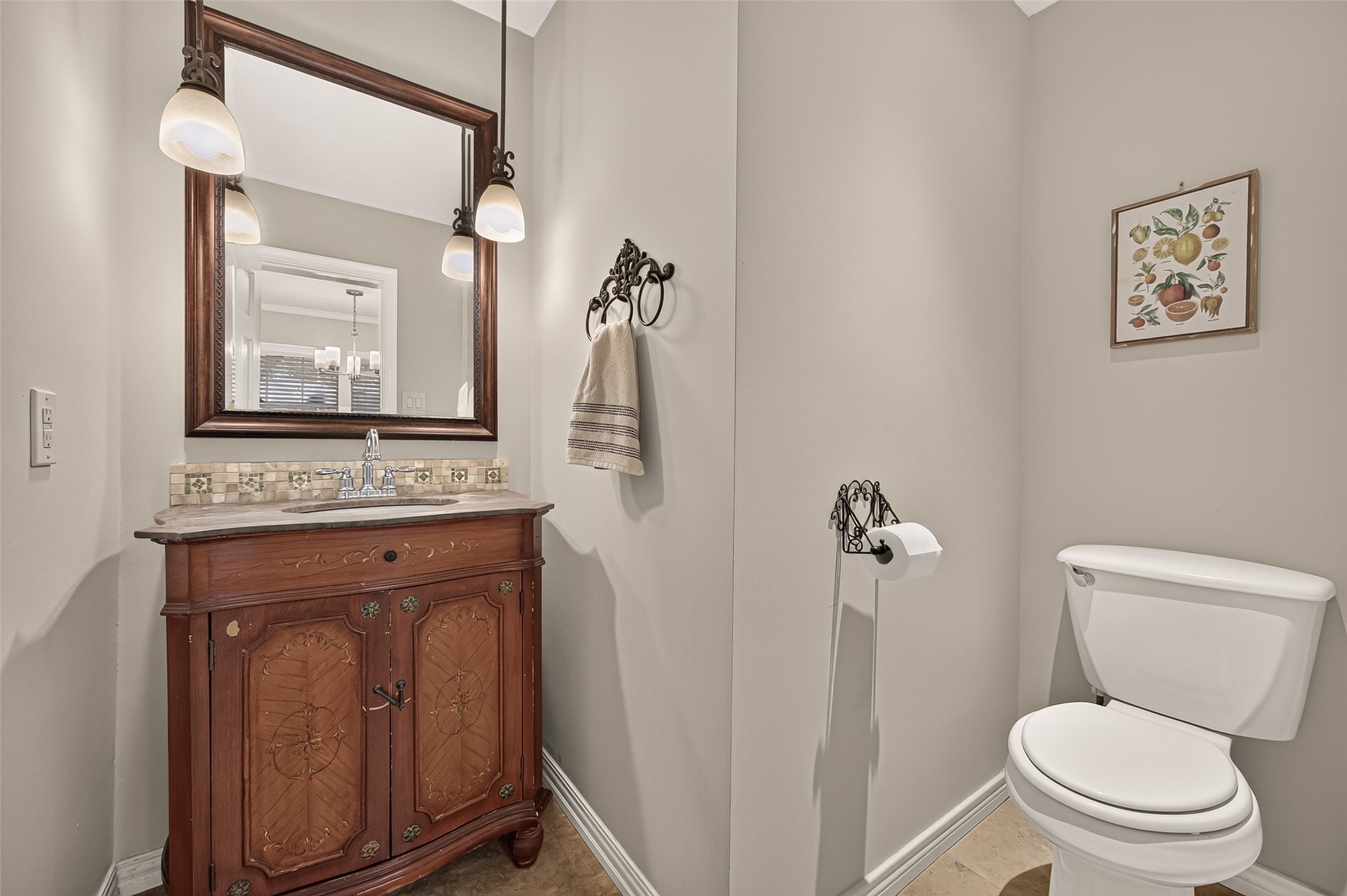 8007 Vickridge Lane Spring, TX 77379 - Photo 10 of 44 Charming half bath features a beautifully detailed vintage-style vanity, elegant lighting, and timeless character