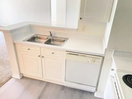 a view of a kitchen with sink washer and dryer