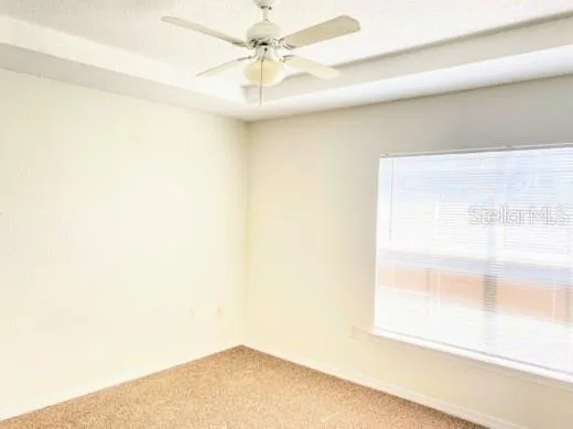 a view of a small space with a ceiling fan and a window