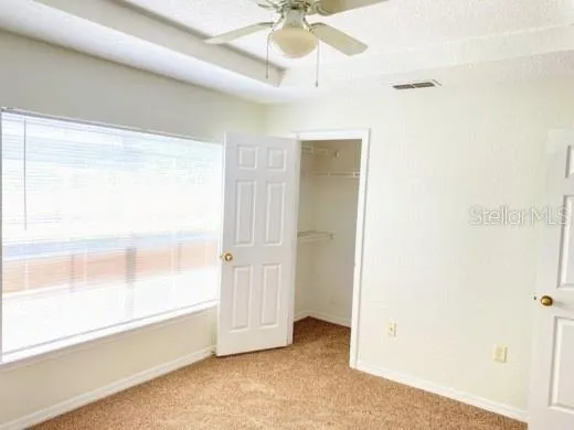 a view of an empty room and a window