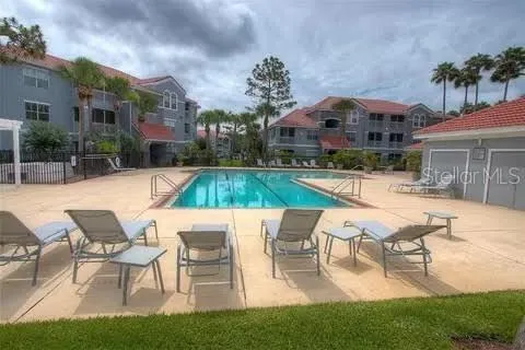 a view of a house with swimming pool and sitting area