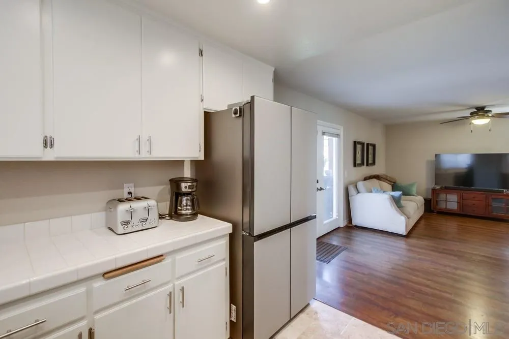 898 Friendly Circle El Cajon, CA 92021 - Photo 16 of 38 a kitchen with stainless steel appliances a refrigerator sink and cabinets