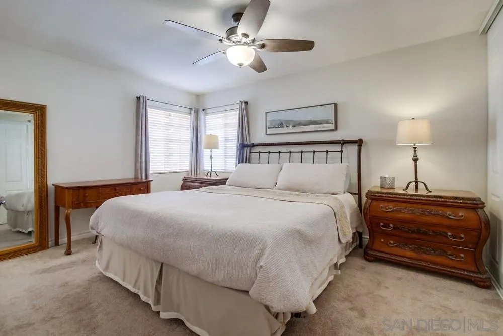 898 Friendly Circle El Cajon, CA 92021 - Photo 19 of 38 a spacious bedroom with a bed and a chandelier