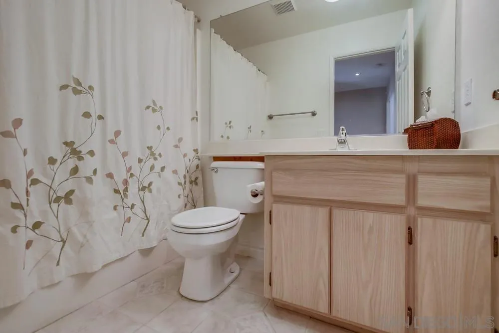 898 Friendly Circle El Cajon, CA 92021 - Photo 24 of 38 a bathroom with a toilet sink and mirror