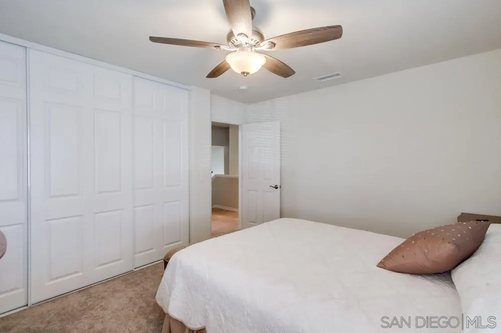 898 Friendly Circle El Cajon, CA 92021 - Photo 28 of 38 a bedroom with a bed and a ceiling fan