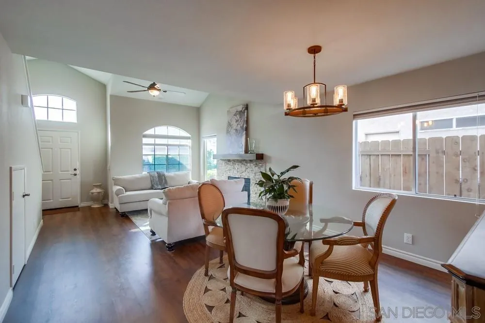 898 Friendly Circle El Cajon, CA 92021 - Photo 8 of 38 a dining room with wooden floor a chandelier a glass table and chairs