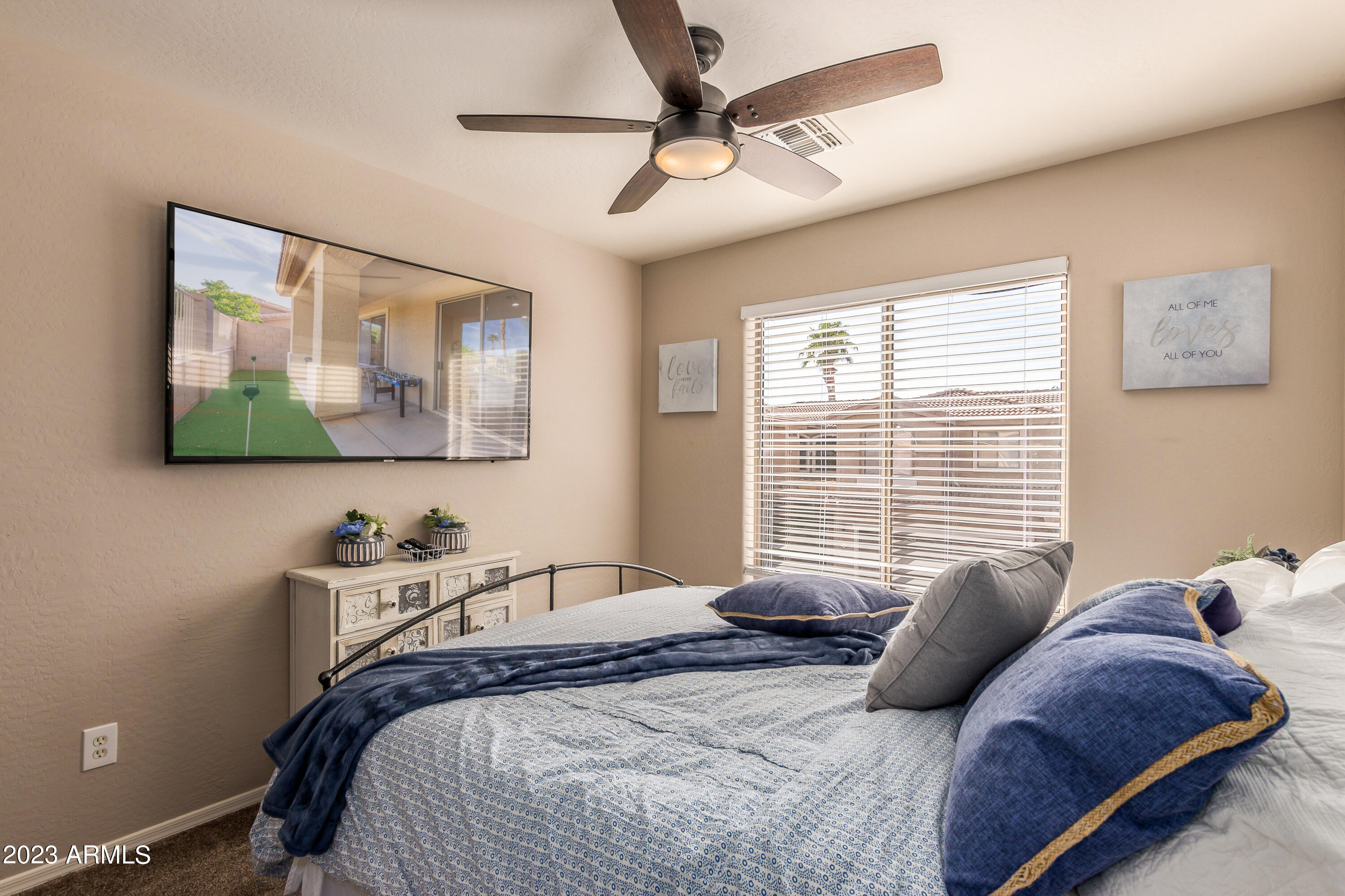 5415 East McKellips Road, Unit 93 Mesa, AZ 85215 - Photo 14 of 64 a bedroom with a bed and a painting on the wall
