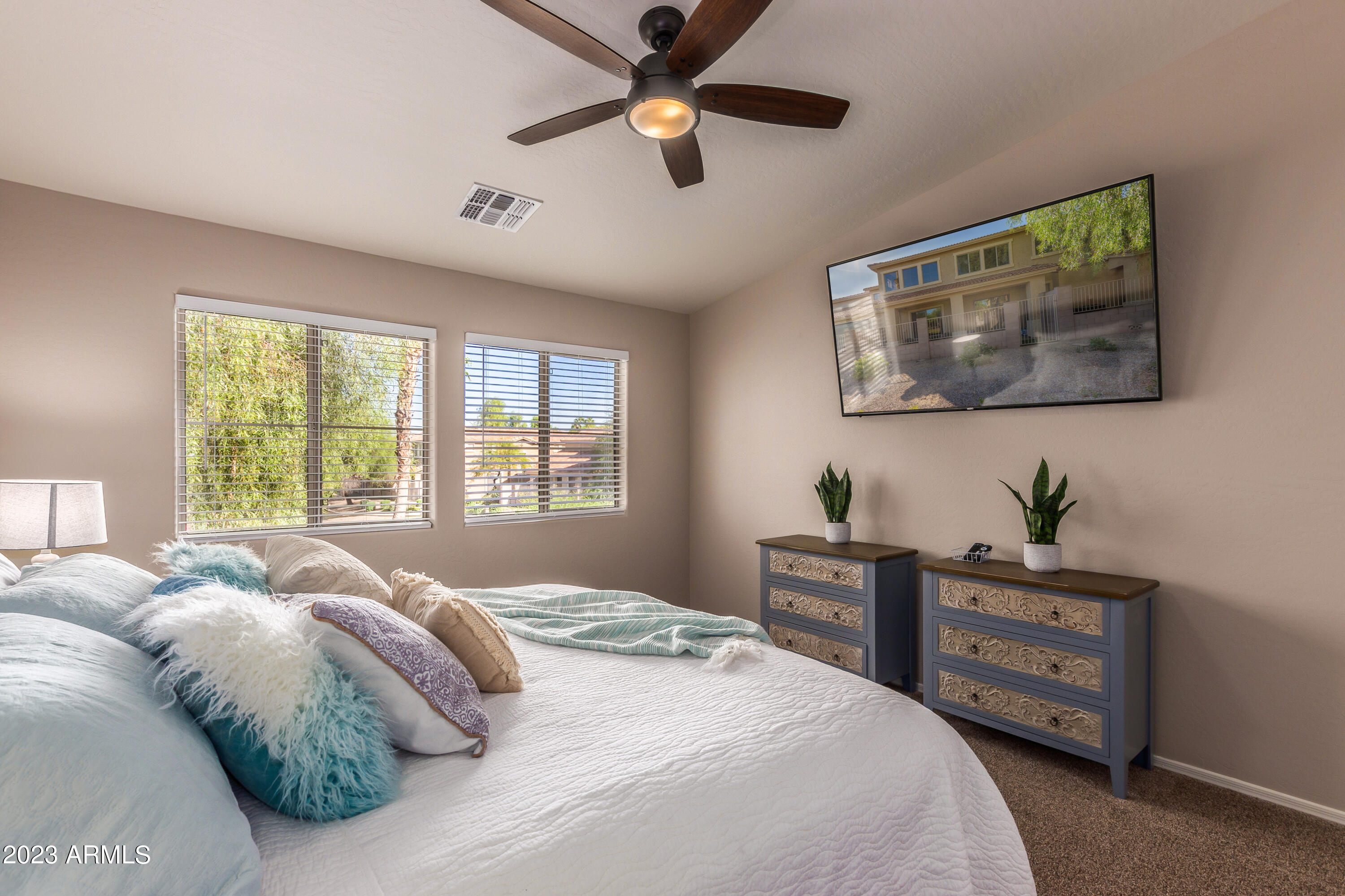5415 East McKellips Road, Unit 93 Mesa, AZ 85215 - Photo 17 of 64 a bedroom with a bed and a chandelier