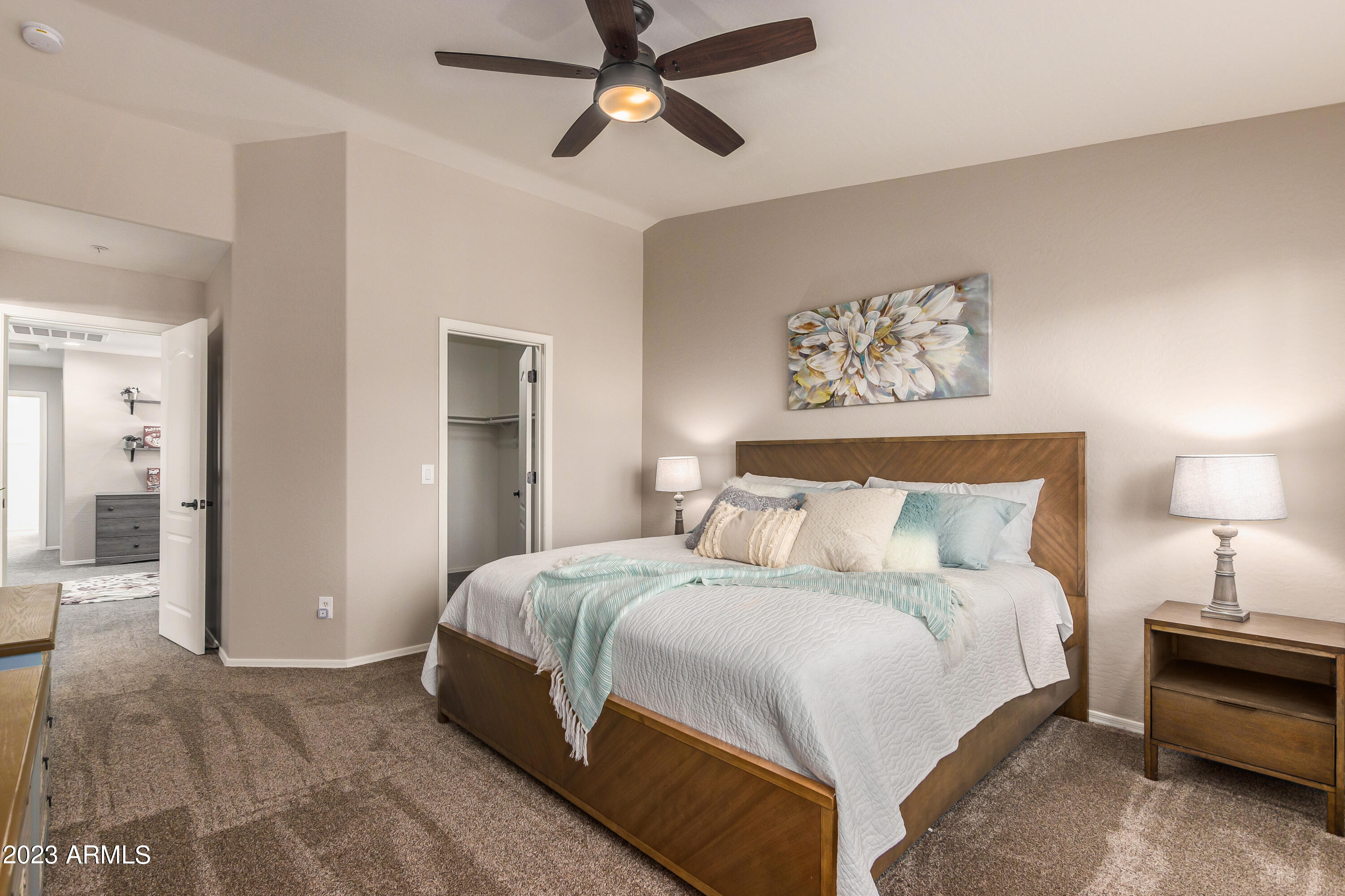 5415 East McKellips Road, Unit 93 Mesa, AZ 85215 - Photo 18 of 64 a spacious bedroom with a bed and a chandelier