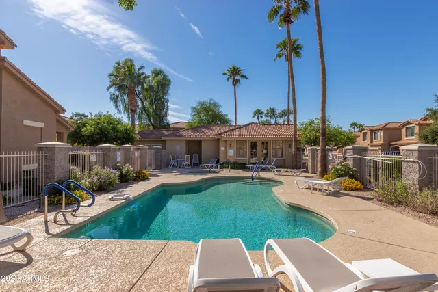 a view of a patio with couches table and chairs potted plants and palm tree