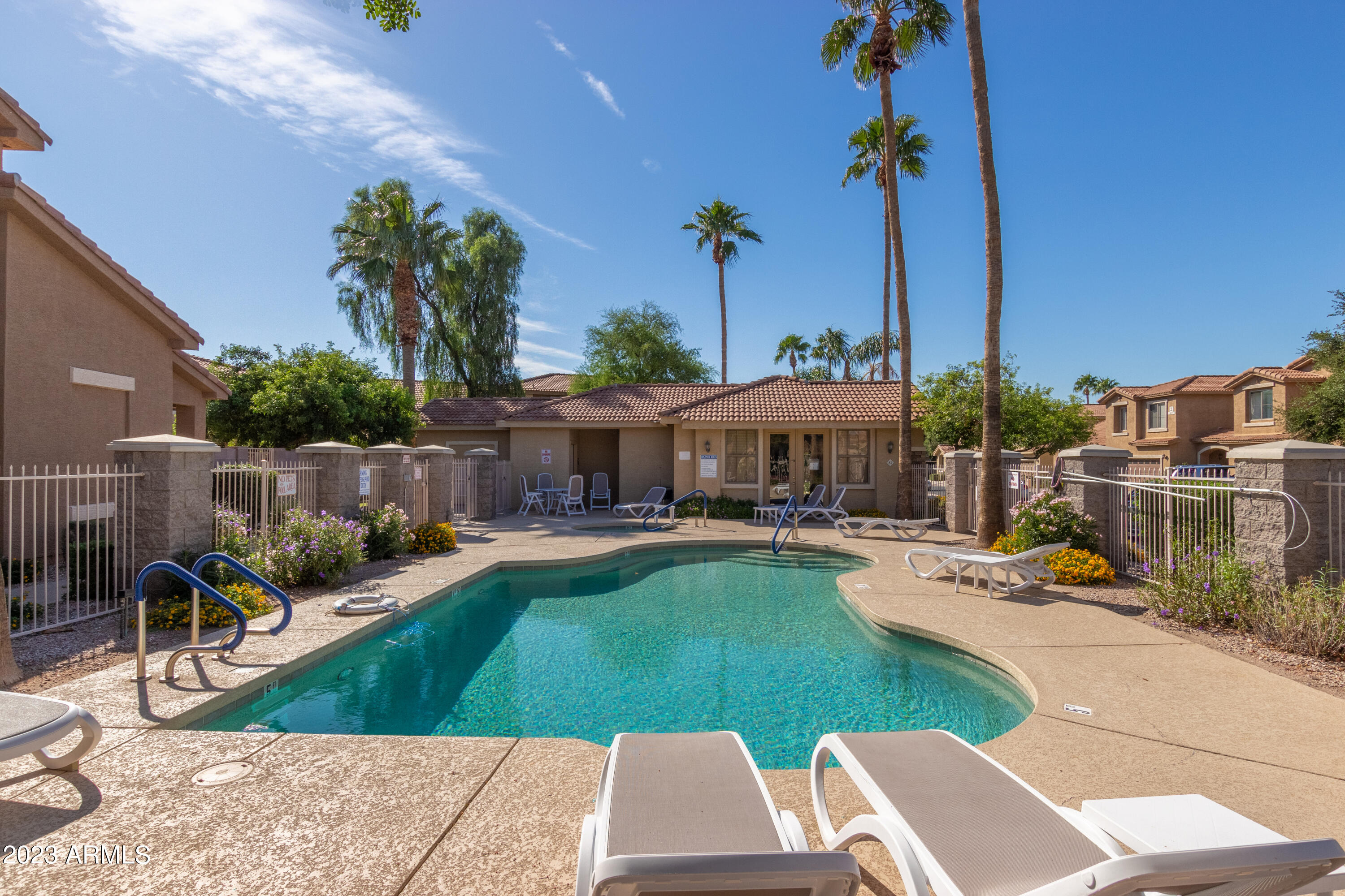 5415 East McKellips Road, Unit 93 Mesa, AZ 85215 - Photo 2 of 64 a view of a patio with couches table and chairs potted plants and palm tree