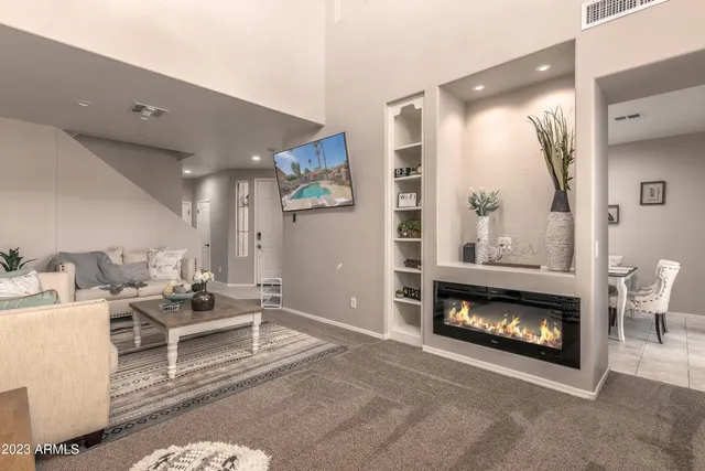 a living room with furniture a window and a fireplace